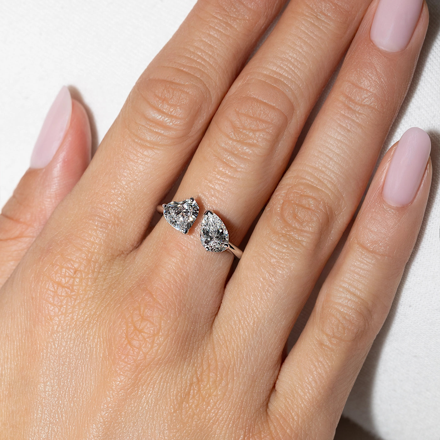 Toi Moi White gold ring with pear and heart shape lab-grown diamonds on finger