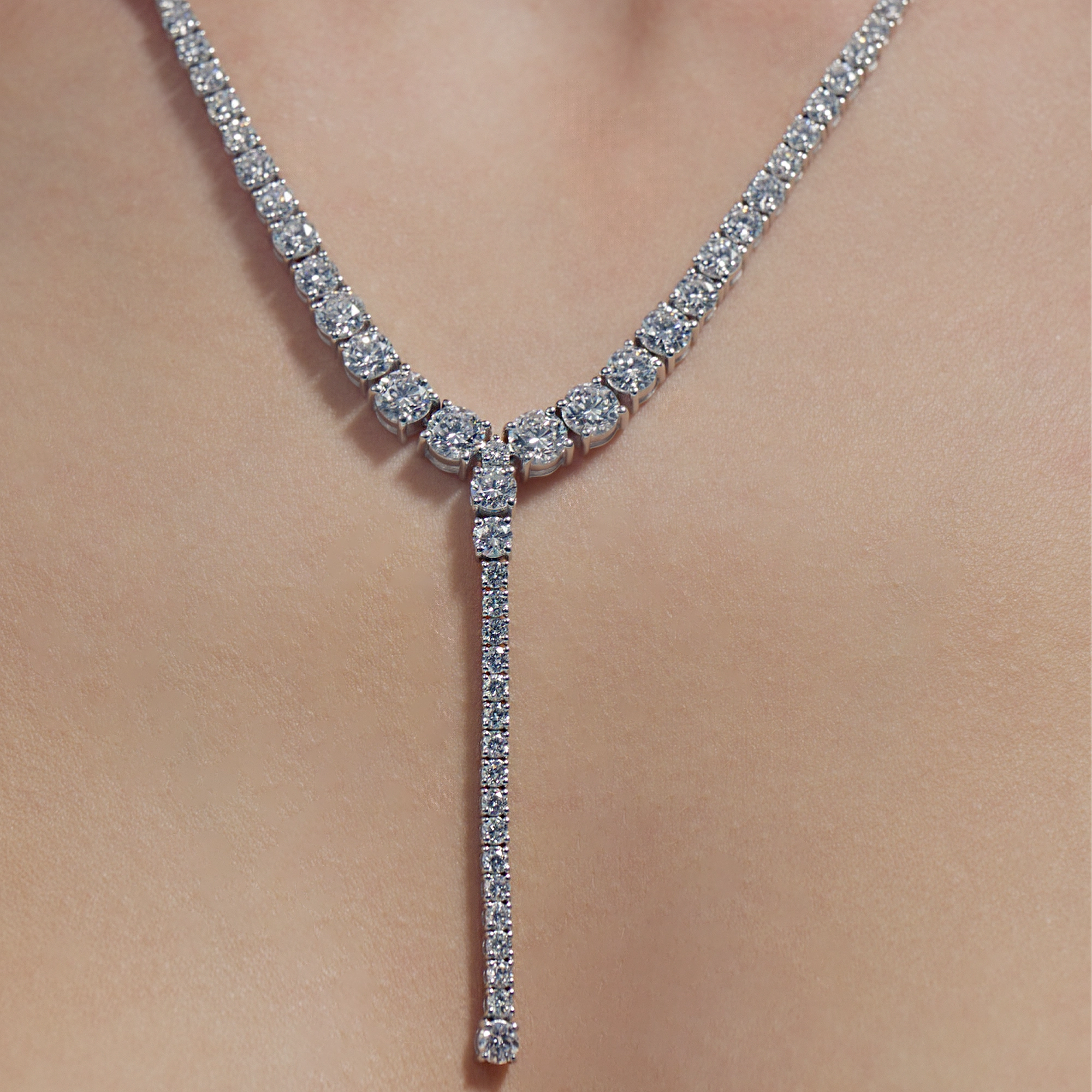 Round Lab Diamond Tapered Drop Tennis Necklace on model's neck