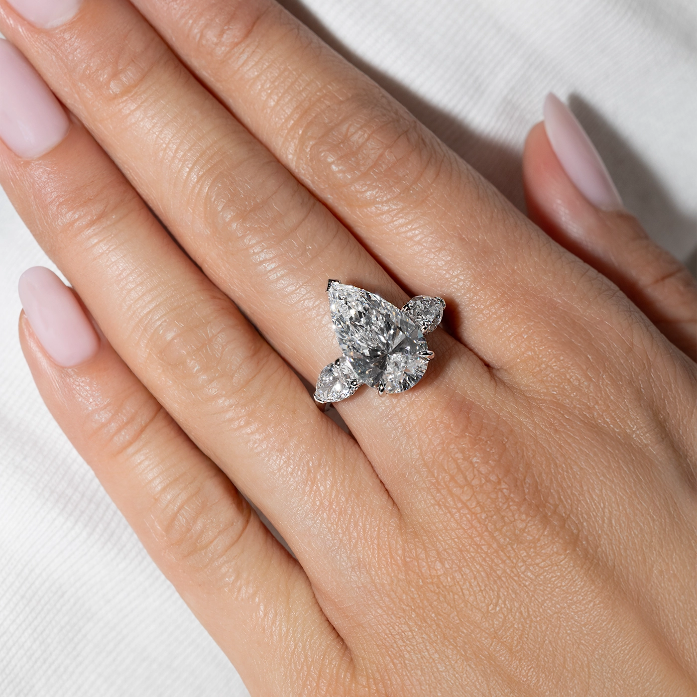 Pear cut lab diamond engagement ring featuring pear-shaped side diamonds in a white gold setting