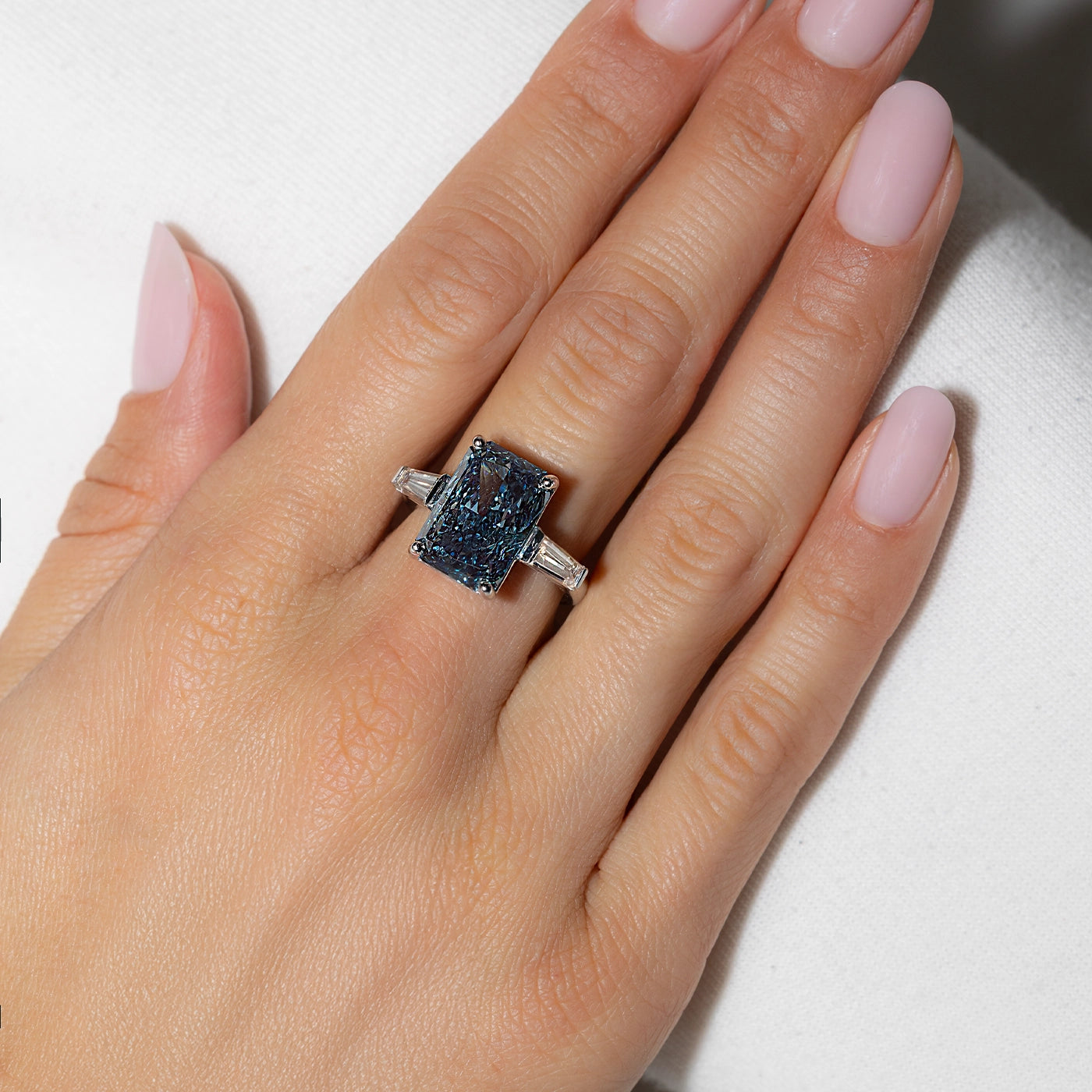 Fancy Vivid Blue Lab Diamond Ring with Tapers as side stones worn on hand