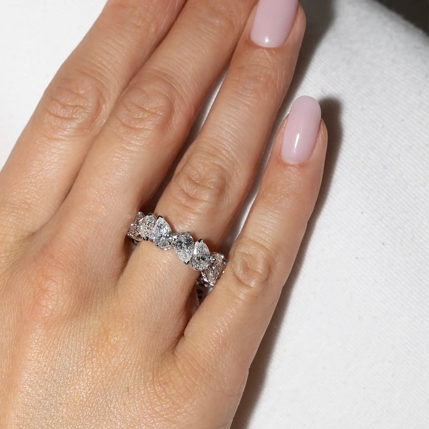 7.57 Pear-cut lab diamonds eternity ring in 18k white gold worn on hand
