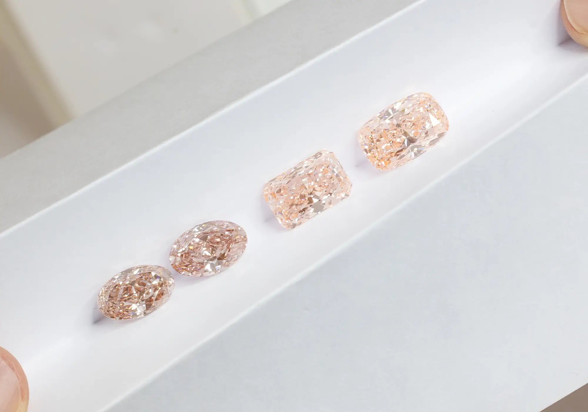 Pink Loose Lab-Grown Diamonds on top of a clean white paper