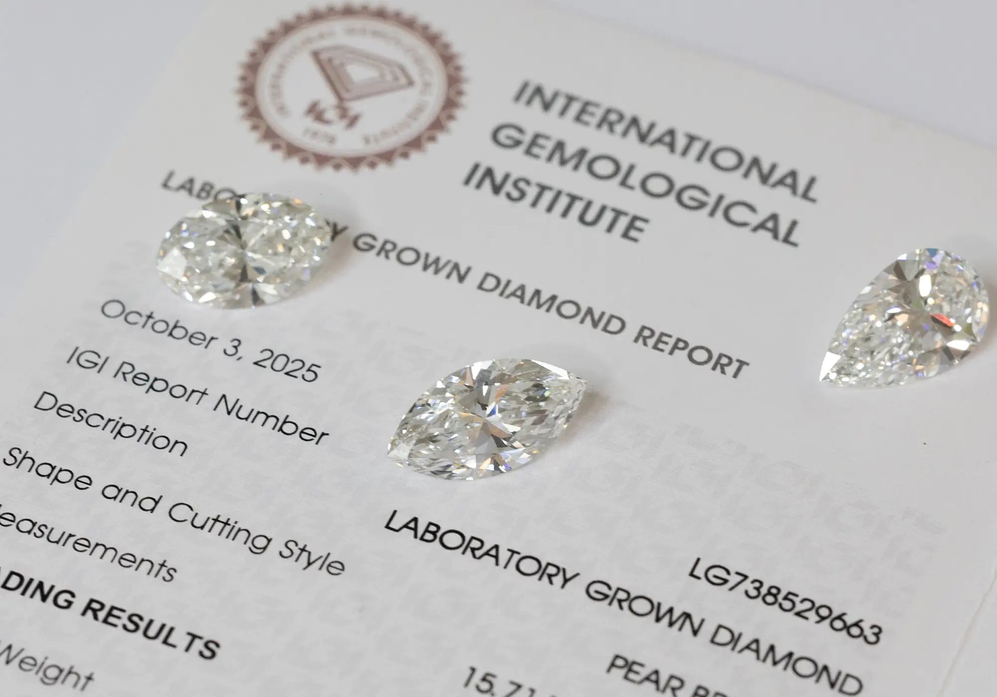 Three diamonds are placed on an IGI laboratory-grown diamond report.