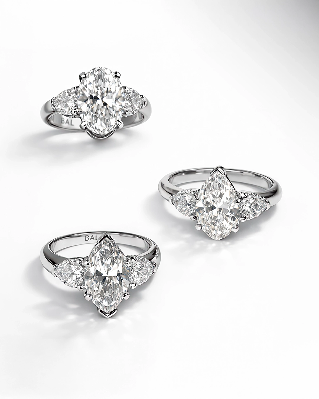 Pear, Oval, Marquise-cut Diamonds in white gold with heart shape side stone with an engravement of BAL Logo 