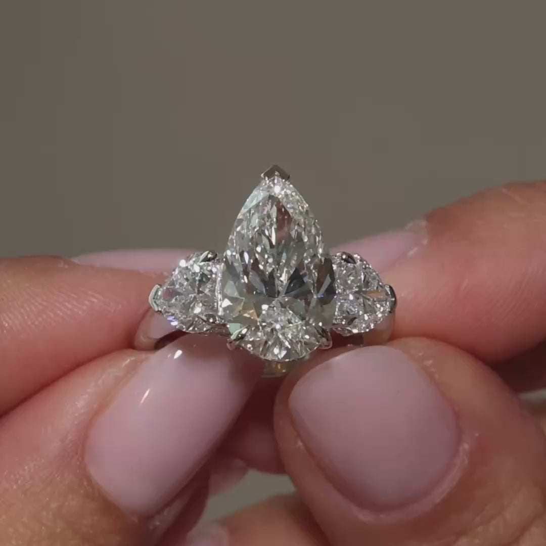 A video clip of pear-shaped lab diamonds heart trilogy in 18k white gold