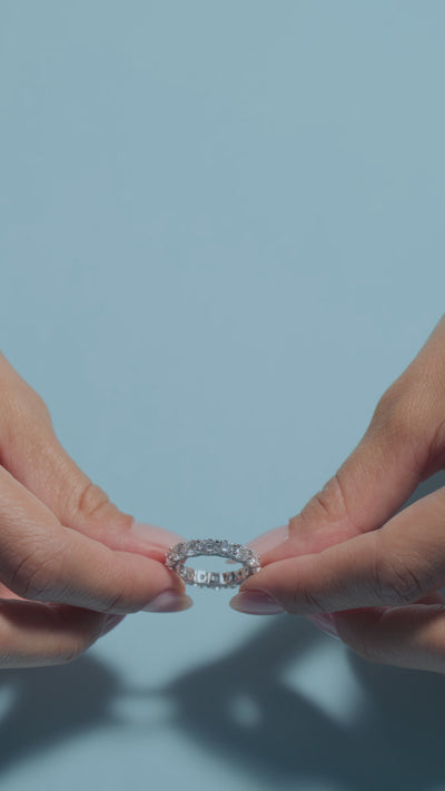 A short clip of a 4.68ct Round Lab Diamonds Intricate Eternity Ring presented by the model of BAL Diamonds on a light blue background 