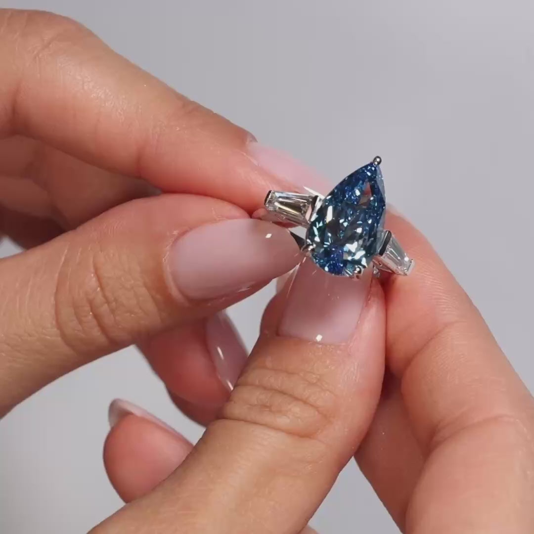 Video showing a 5ct Pear Fancy Vivid Blue Lab Diamond Tapers Trilogy 