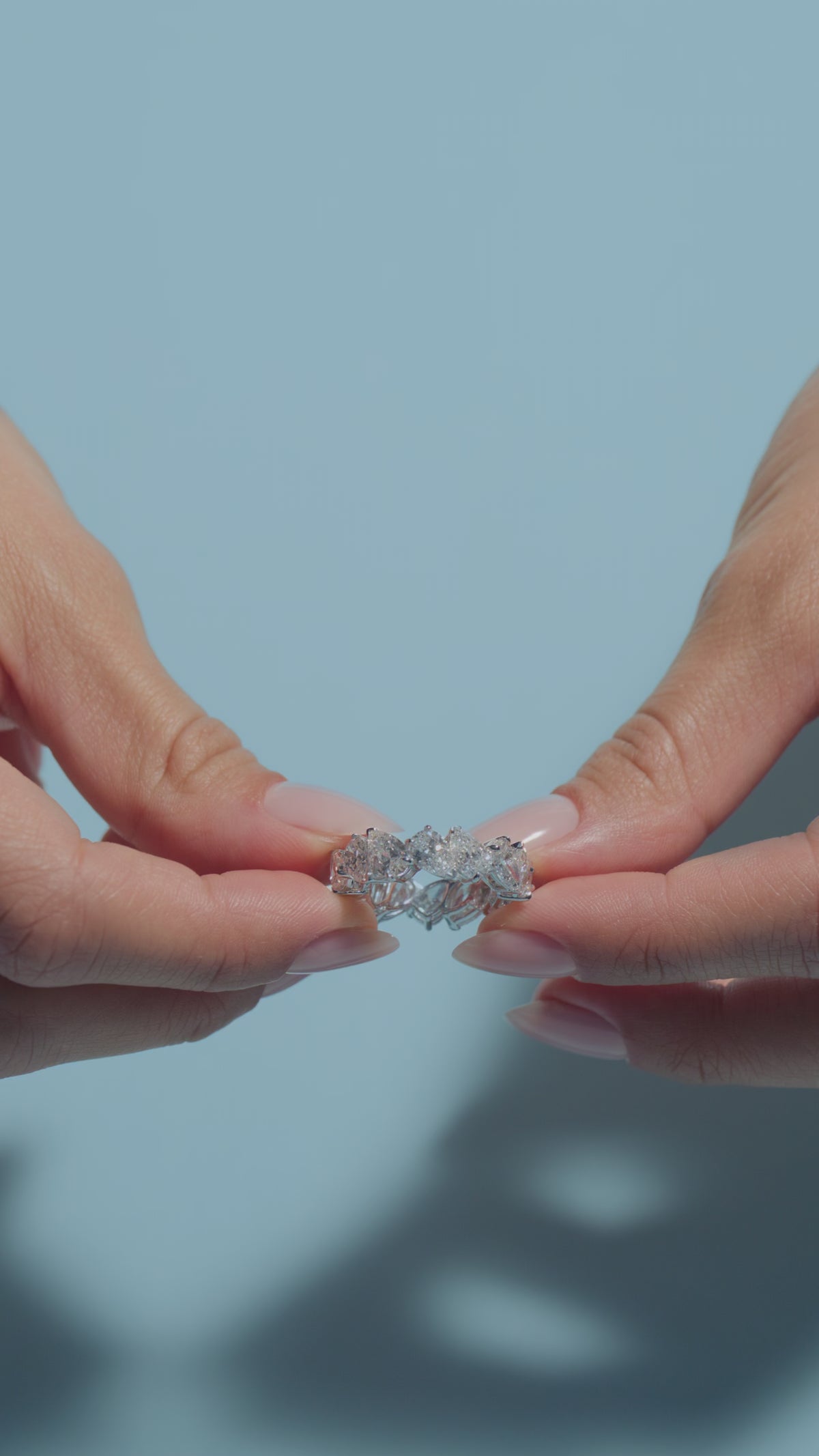 A short video featuring a 7.57ct Pear Lab Diamonds Eternity Ring held by the model of BAL Diamonds on a light blue background 