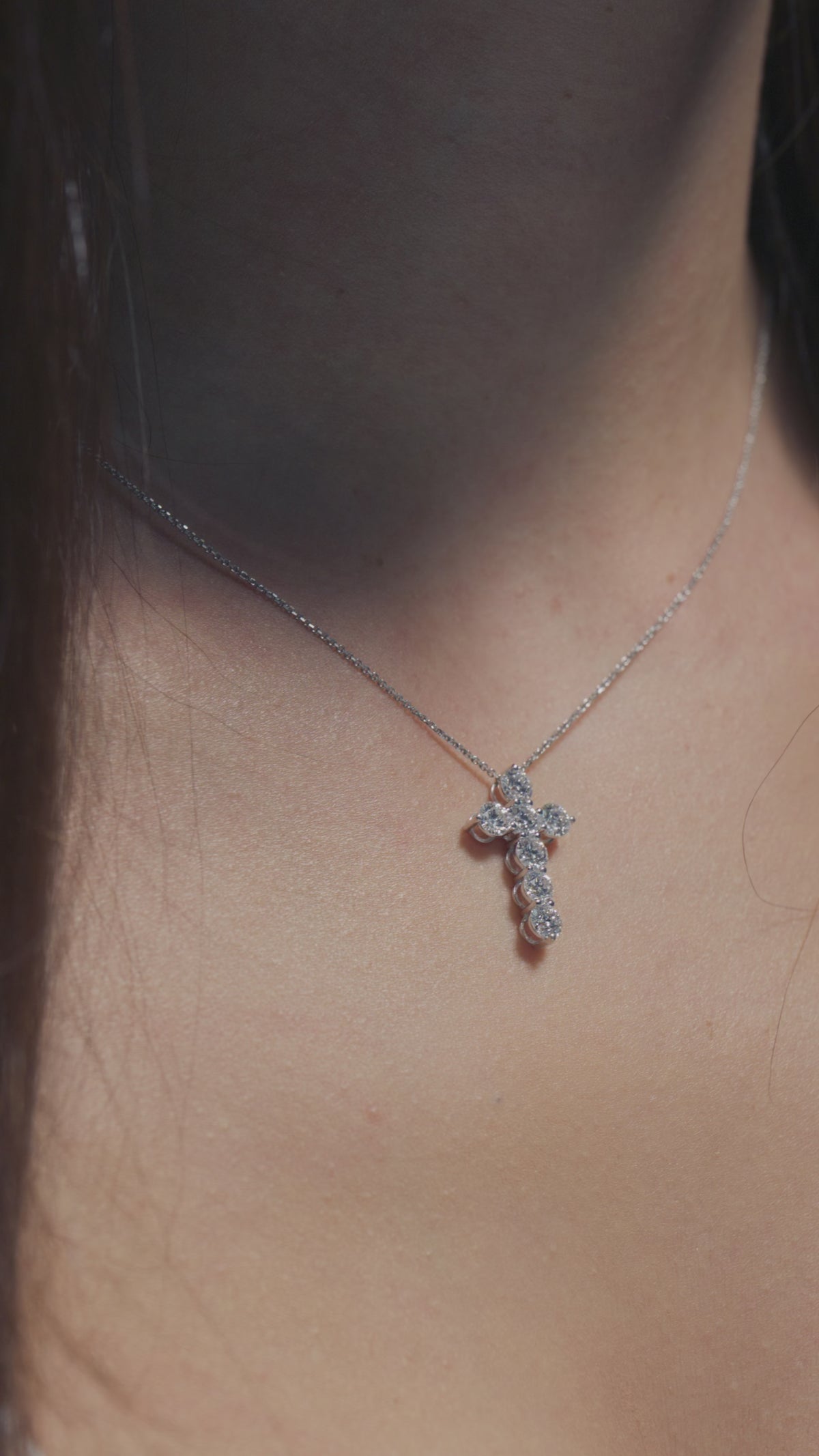A video showing off a  1.79ct Round Lab Diamonds Cross Pendant worn on the neck of the model 