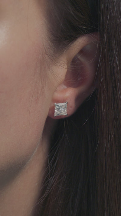 A video presentation of a 2ct Princess Cut Solitaire Earrings worn on the lobe of a model 
