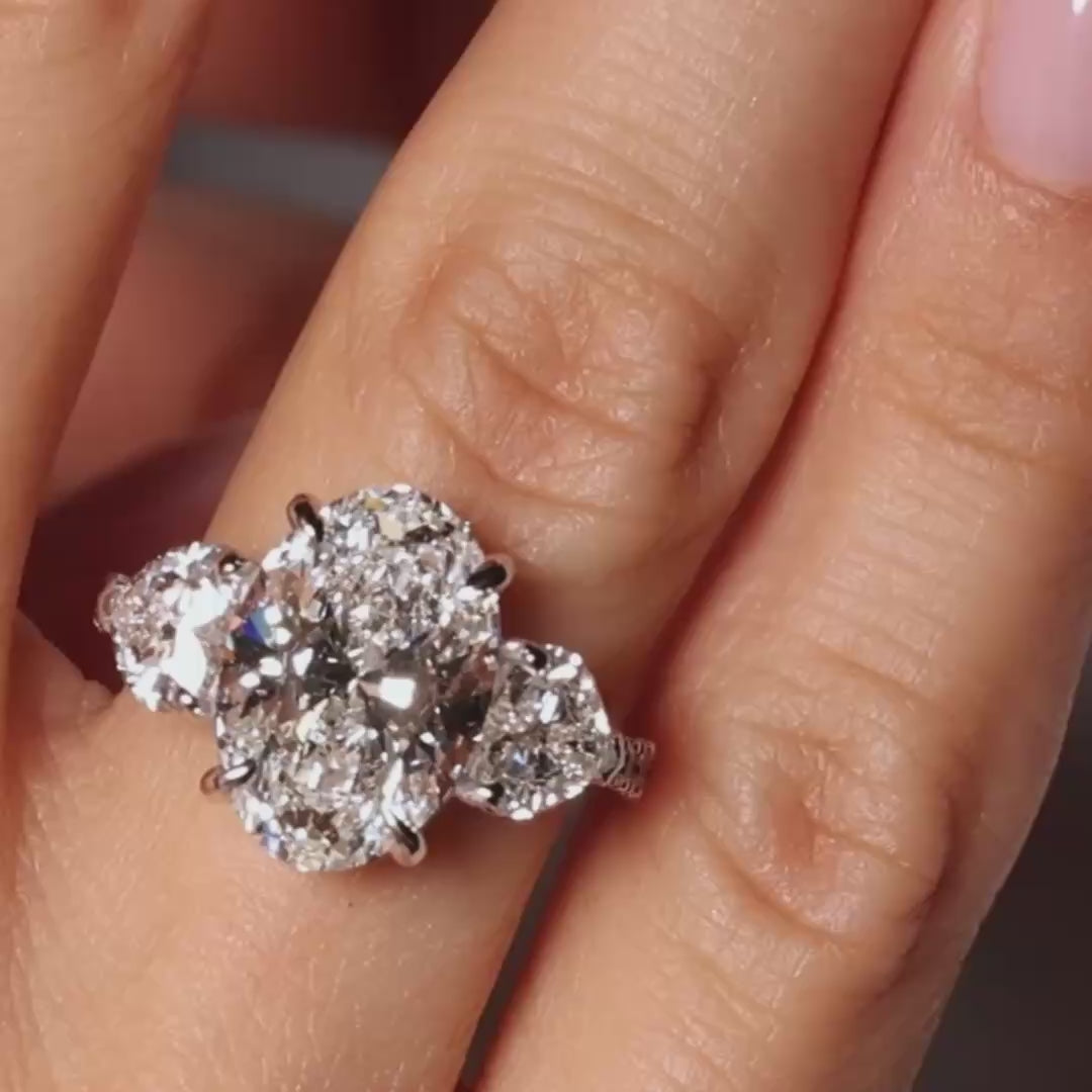 Oval lab-grown diamond heart trilogy ring with reverse shank, 18K gold, close-up video showcasing design and sparkle