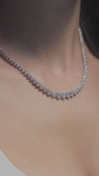 A video of 16.87ct Round Lab Diamond Tapered Tennis Necklace shown off by the model 