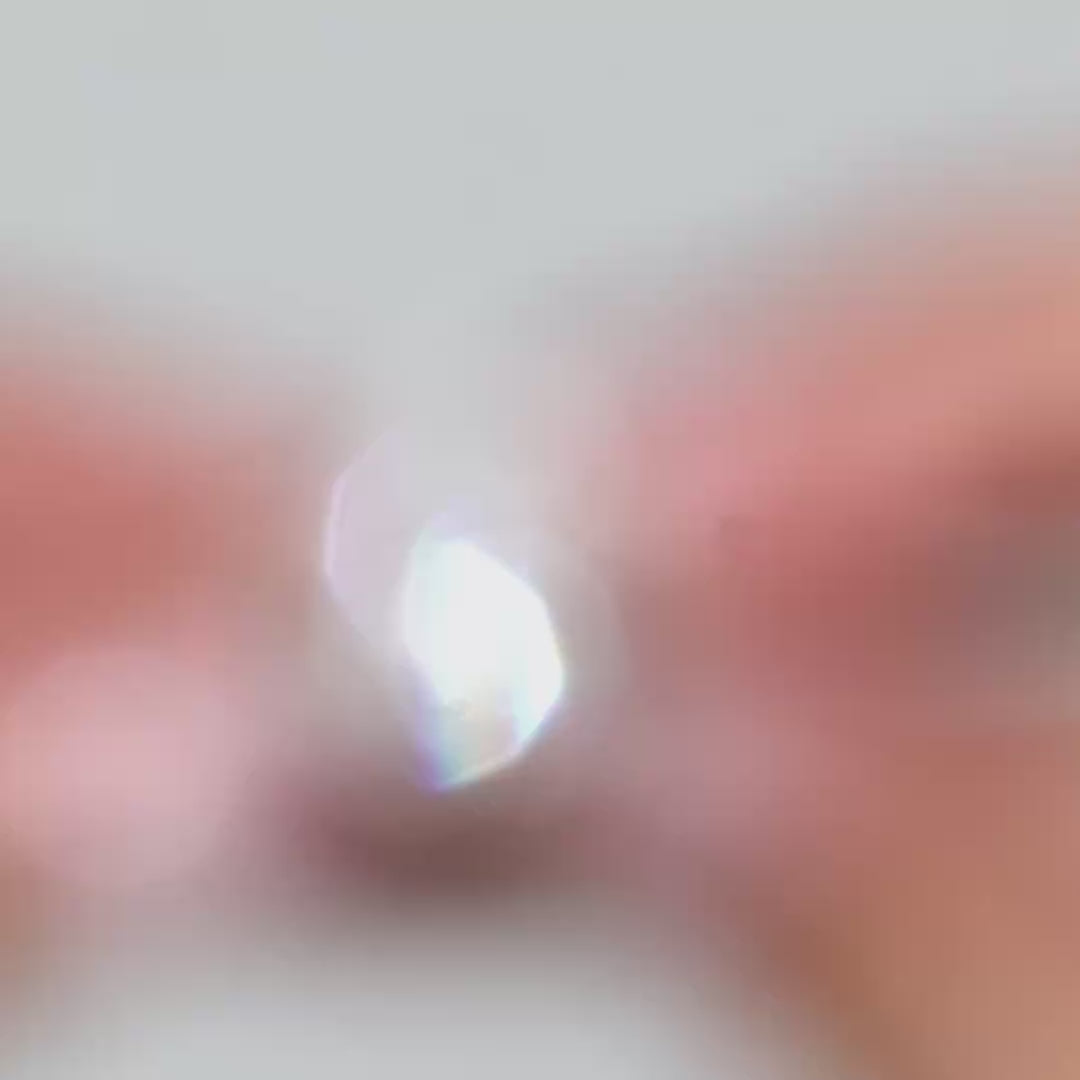 Video of a pear-shaped lab diamond with pear side stones showcased by the model 