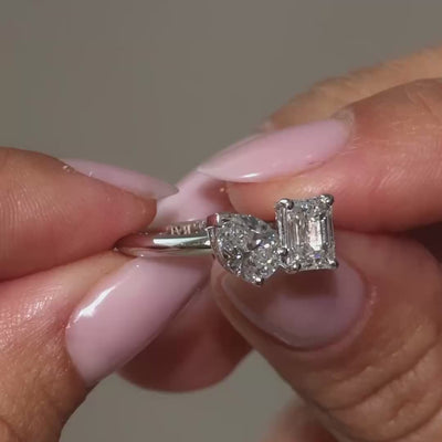 A short clip of a Pear-Emerald Lab Diamonds Toi&Moi Ring held by the owner